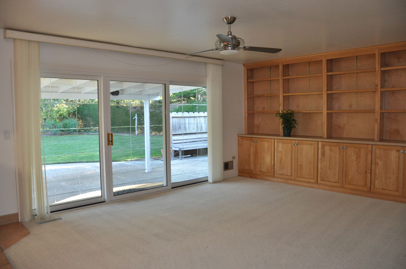 Den off kitchen has custom built-in bookshelves, cabinets and pantry.