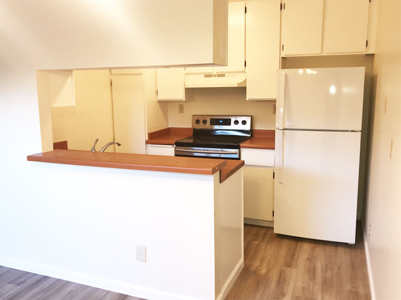 Townhome kitchen includes a refrigerator and stove.