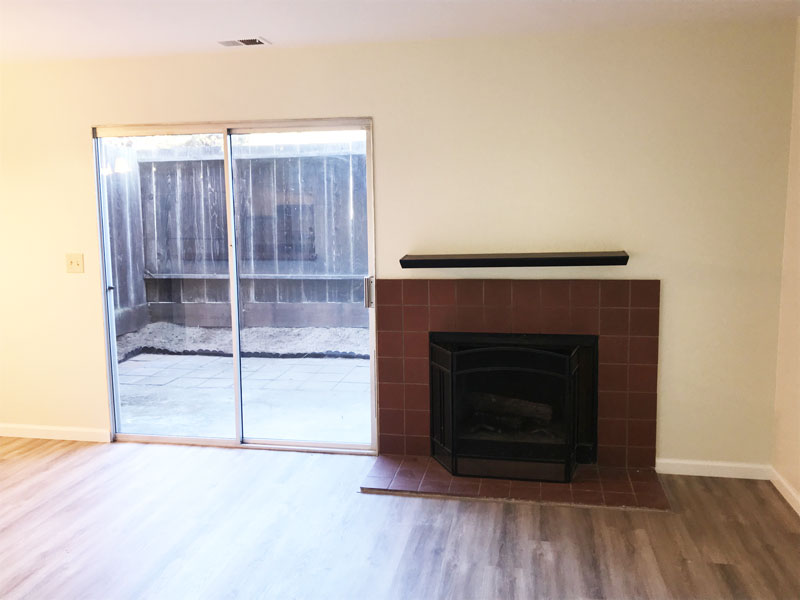 Livingroom has fireplace and access to fenced backyard.