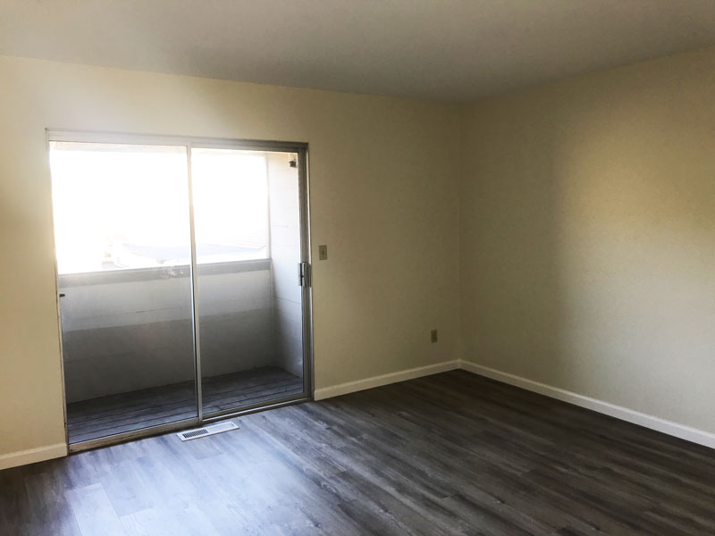 Master bedroom has balcony and new laminate flooring.